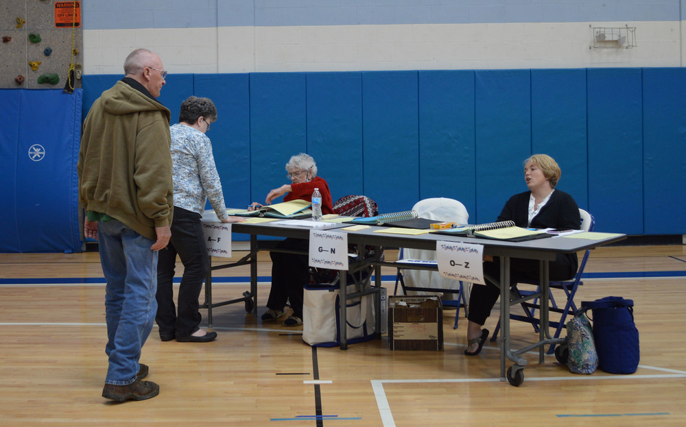 Two voters get ready to sign in at the Roscoe voting site