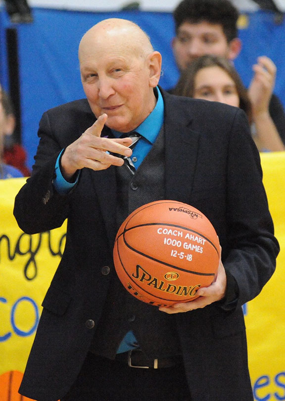 Coach Fred Ahart hold a basketball for his 1,000th win